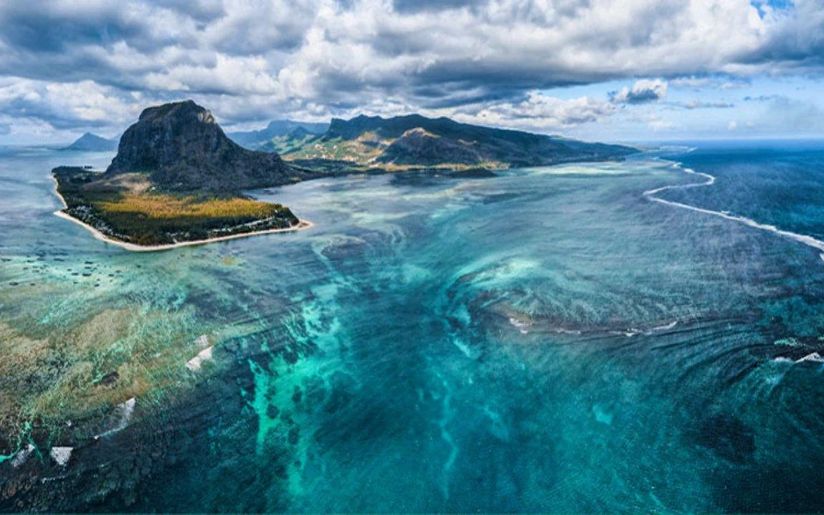 The Le Morne peninsula from the air, with pale channels of sand fanning out across the shelf